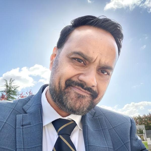 Tanzil Rahman wearing a suit outside